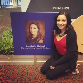 Dr. Labib next to poster