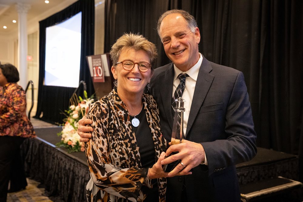 Dr. O and Alan Lindy holding lighthouse award