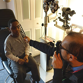 Dr. Trujillo providing an eye exam to a pediatric patient