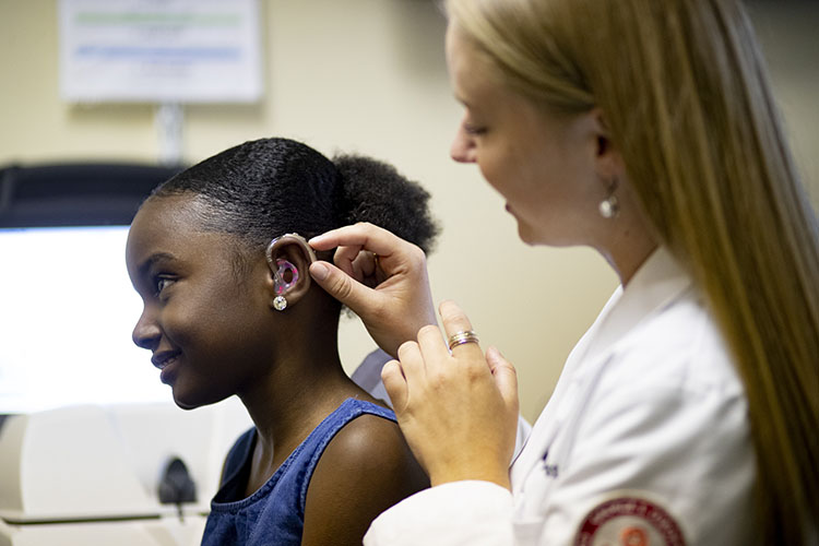 young girl fitted for hearing aid