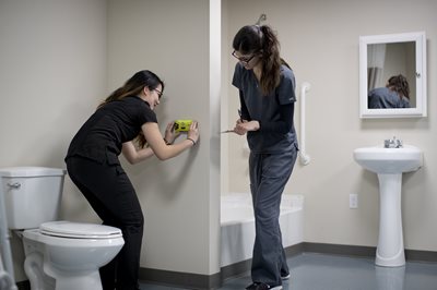 OTs modifying a bathroom for a patient