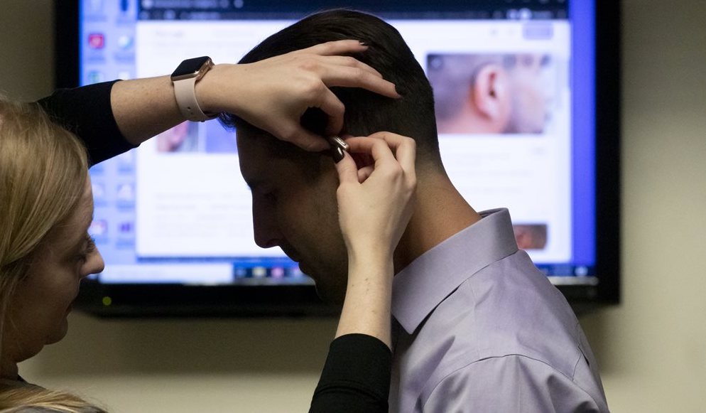 patient being fitted for hearing aid