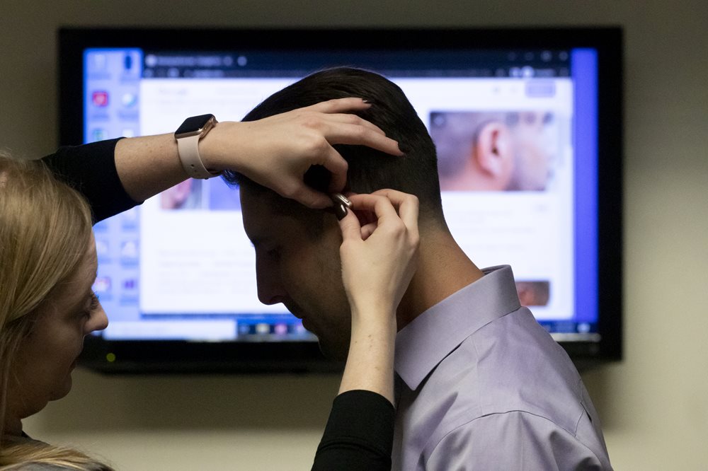 Young man getting hearing aid