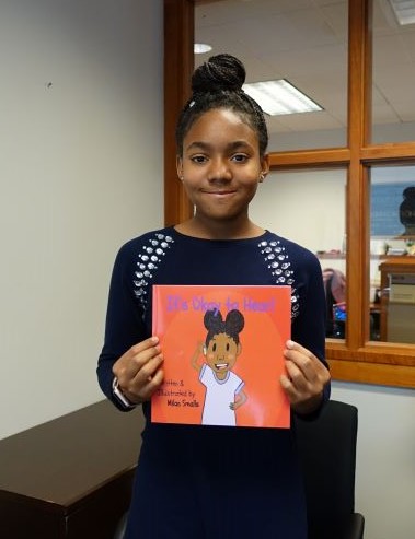 Milan Smalls holding her book