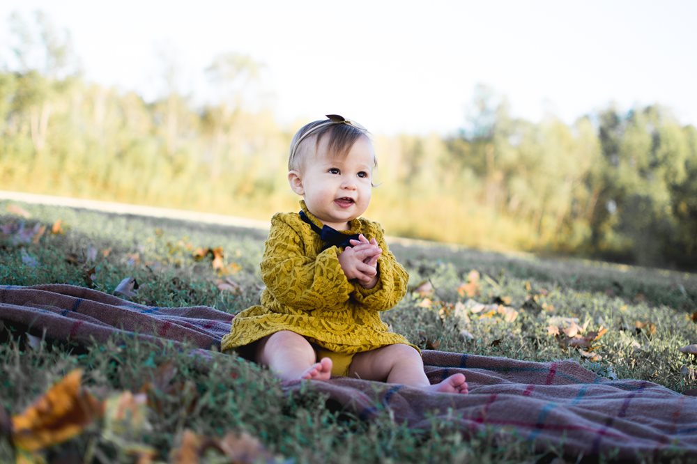 Baby sitting in a field