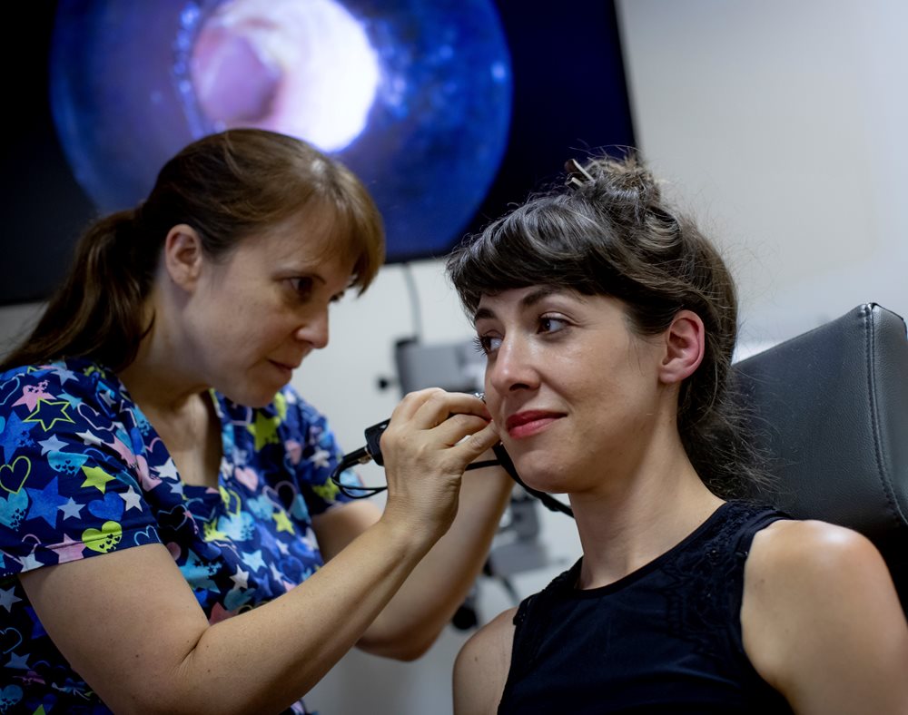 Patient having ear cleaned