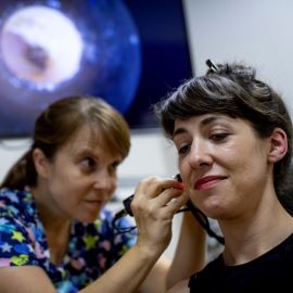 Dr. Bondurant cleaning patient's ears