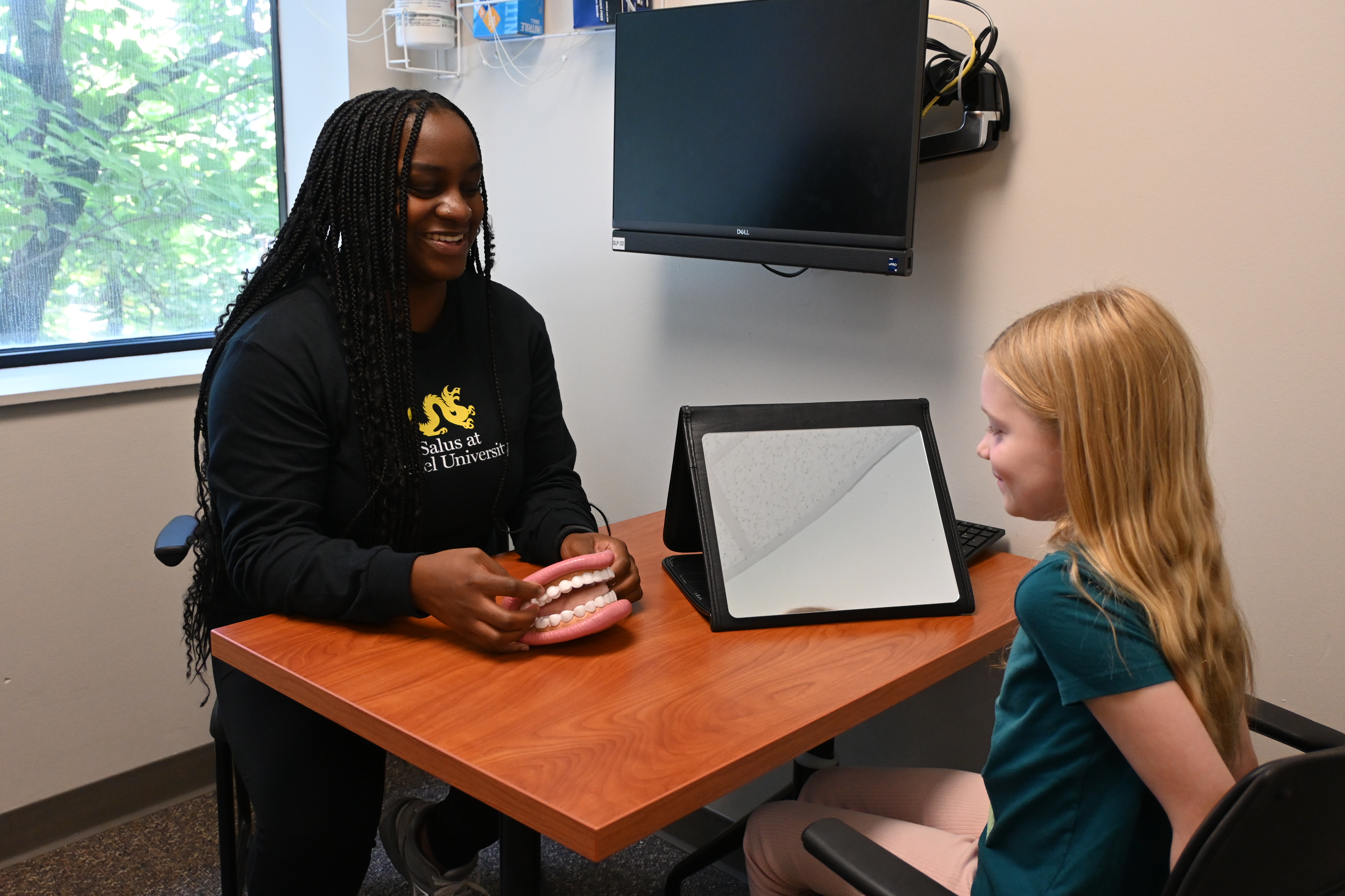 Children getting examined by SLI student