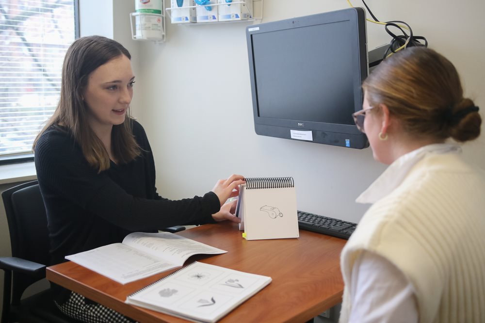 Speech Language Pathologist with patient