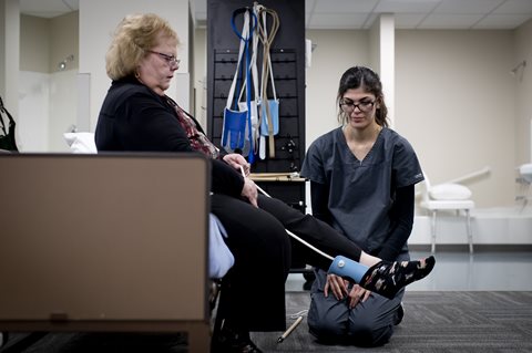 woman using sock assist device