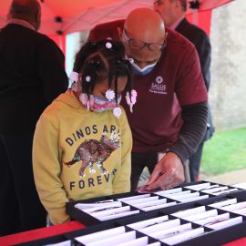 Young girl picking out glasses