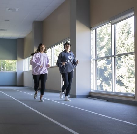 Two women running laps