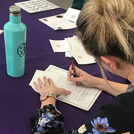 woman writing a thank you card