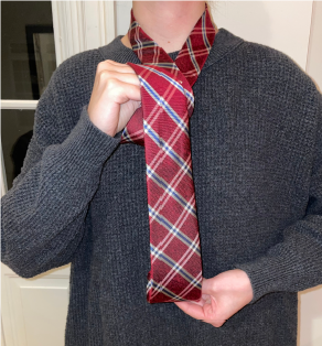 Person tying a tie