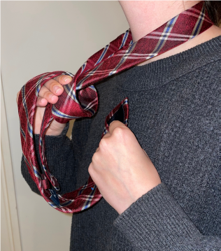 Person tying a tie