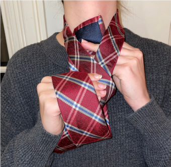 Person tying a tie