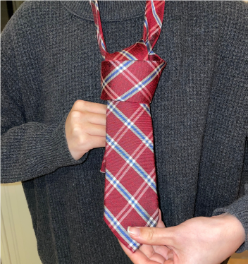 Person tying a tie