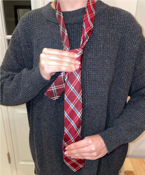 Person tying a tie