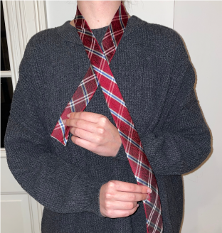 Person starting to tie a tie