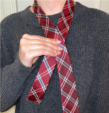 Person tying a tie