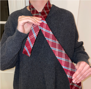 Person tying a tie