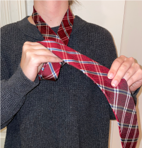 Person tying a tie