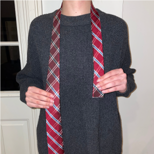 Person holding a tie around their neck