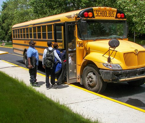 Students walking onto the school bus