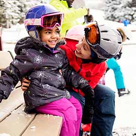 Mother and daughter snowboarding