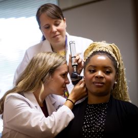 Woman having ear exam