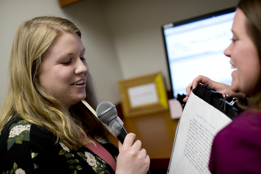 Woman talking into a microphone