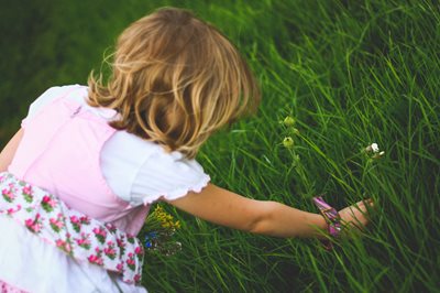 young girl picking flowers