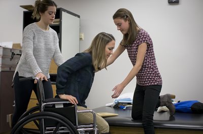 OTs working with a patient in a wheelchair